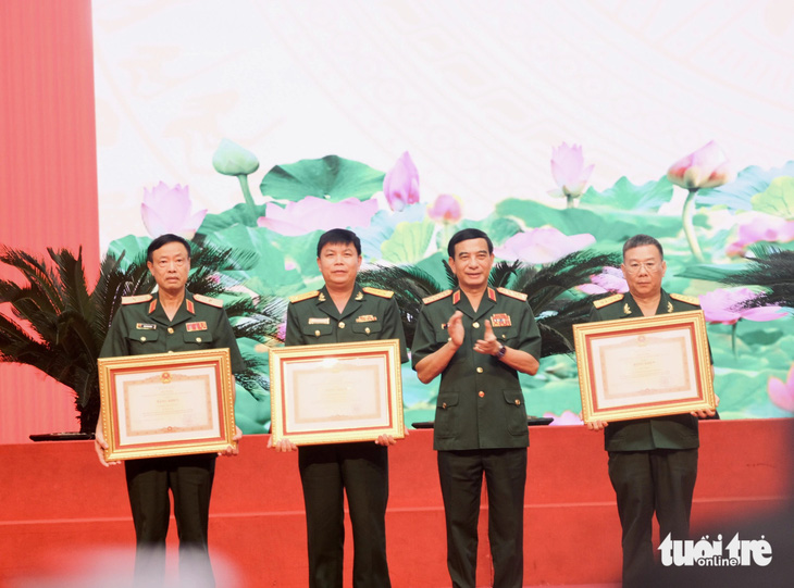 Đại tướng Phan Văn Giang: Tuổi trẻ quân đội xung kích phát triển khoa học quân sự- Ảnh 2. Đại tướng Phan Văn Giang - bộ trưởng Bộ Quốc phòng - trao bằng khen của Thủ tướng Chính phủ cho ba tập thể - Ảnh: HÀ THANH