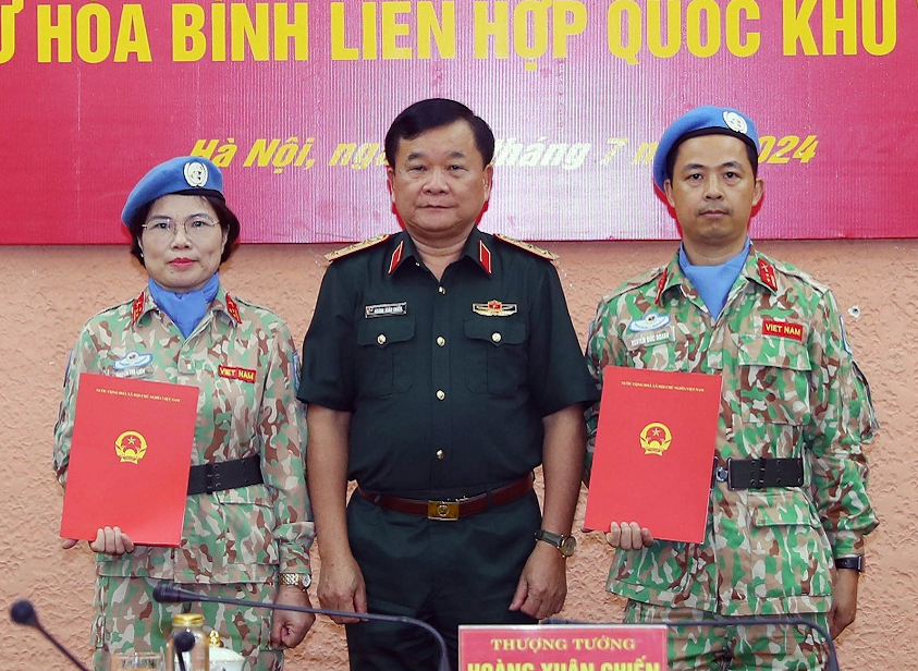 Thượng tướng Hoàng Xuân Chiến trao Quyết định của Chủ tịch nước cho hai sĩ quan đi làm nhiệm vụ tại Abyei. Ảnh: Trọng Đức
